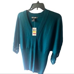 Green V-neck sweater. Made by United State’s sweater. Size Medium